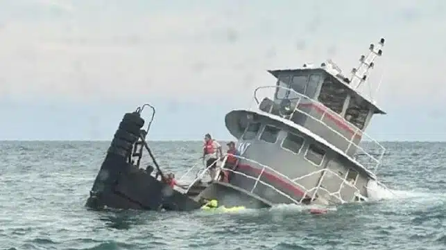 Rewrite Please As a 3rd Party In 4 - 5 Paragraphs With 1 Title The NTSB has released its investigative report on the sinking of the tug Jacqueline A, which sank in the Atlantic off the coast of South Carolina. The vessel went down because of corrosion holes in small void spaces above the lazarette, leading to water ingress and progressive flooding through unsealed wire runs between compartments. Jacqueline A was a 60-foot tug built in 1981 as the Eric Paul. Since 2012, she had been in service with a small towing company in Weems, Virginia, and was used for barge tows on the Chesapeake Bay. She was taken out of service in 2019 because she was not compliant with the newly-crafted Subchapter M regulations for towing vessels, and was laid up for several years. In mid-2023, the vessel's owner decided to return Jacqueline A to service and contracted with a yard in Louisiana to make upgrades and repairs. The owner hired a captain, mate and deckhand for a transit voyage to deliver the vessel to the yard. The captain said that the vessel's mechanical spaces looked to be in great shape, but the lazarette was not visually inspected immediately prior to the voyage (it had been checked three months earlier during a yard period). The master got under way on August 6, 2023, and headed for the Intracoastal Waterway. As the weather improved, the master decided to take an open-ocean route from the Cape Fear River inlet in North Carolina to Port St. Lucie, Florida, saving time. At about 1350 hours on August 8, the Jacqueline A left the Cape Fear River channel and headed southwest along the coastline. The seas were on the port beam at four feet, and the vessel was "rolling pretty good," according to the mate. The aft deck was taking water over the bulwarks, not unusual for a towing vessel in rough weather. Conditions subsided over the next few hours, but sea spray continued to wash over the vessel periodically. Between 1830-1850, the captain - who was on watch - noticed that the tug had taken on a port list. He went out of the wheelhouse on the port side to look aft, and he saw that the main deck was underwater up to the edge of the deckhouse. The master checked the engine room and found that water was spilling in from the two wire runs that connected the engine room to the lazarette. (Jacqueline A had two four-inch pipes running from the aft engine room to the lazarette, through the potable-water tanks. They were unsealed and open-ended.) There was water in the bilge up to the bottom of the engine on the port side. The crew attempted to start bilge pumps, but the situation rapidly deteriorated, and the Jacqueline A quickly took on a severe port list and aft trim. At 1856, the master made a mayday call and gave the Coast Guard the vessel's position - just in time, as the generator shut down and took out the radio shortly after. The Jacqueline A began to go down quickly by the stern, but as she was only in 31 feet of water, her downward progress was arrested when her hull struck the bottom. The bow remained above the surface, and the crew moved forward of the wheelhouse, where they stayed to wait for a rescue. Three near-shore response boats from local agencies arrived at about 1940 hours, and they took the crew aboard for safe delivery ashore. No injuries were reported; the Jacqueline A fully sank after the rescue. The vessel was raised by a salvage crew on August 21. The Jacqueline A's systems had sustained extensive damage throughout, and the cost of repairs was more than the value of the tug, so she was declared a total loss. During a post-casualty inspection, the inboard plating of the bulwarks was cut away, and revealed wastage with holes of 2-8 inches in diameter on the deck plating of the small void spaces inside. The exterior of the bulwarks also showed substantial wastage, some of which had been covered with fiberglass patches. The port engineer had identified the enclosed bulwarks as a hazard earlier, and they were due for removal during the Louisiana yard repair period. There was also a previously-undetected hole on the stern hull plating - the aft bulkhead of the lazarette - that was less than one inch in diameter. Gaskets were also missing from weathertight doors on the deckhouse. The Coast Guard's Marine Safety Center concluded that as Jacqueline A's lazarette began to flood and the stern sank lower, the holes in the deck would have accelerated the rate of water ingress. Once the lazarette filled, it would have begun flooding the engine room via the unsealed wire runs at up to 1,100 gallons a minute. From start to finish, once the aft deck was submerged, the tug would have gone down in 9-16 minutes. "The lazarette was a relatively small space compared to the engine room. If the wire runs had been sealed, flooding would have been contained to the lazarette, and the vessel likely would have remained afloat," concluded NTSB. The agency cautioned operators, yards and designers to avoid creating small void spaces, where moisture can accumulate undetected and lead to severe, undetectable corrosion. It also reminded owners of the need for proper sealing of wire runs and other penetrations through bulkheads, since holes enable progressive flooding. Informally, NTSB noted that the crew could have observed the vessel's "poor material condition" when they arrived at the pier and should have conducted a more thorough inspection - including opening up the lazarette for a visual examination - before getting under way.