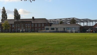 The school in the shadow of giant 'cruise ship' warehouses where children wade