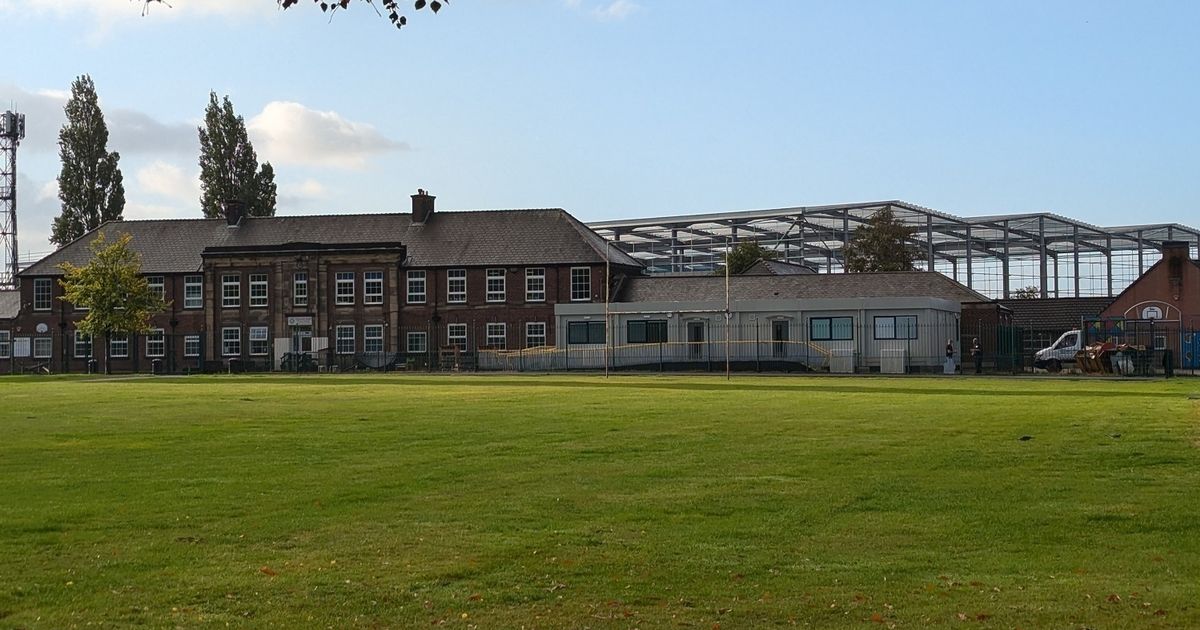 The school in the shadow of giant 'cruise ship' warehouses where children wade
