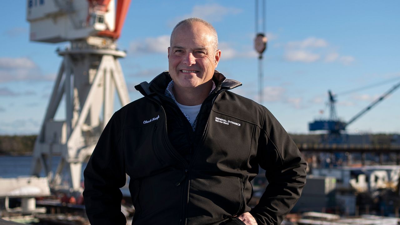Charles F. Krugh, president of Bath Iron Works, poses at the shipyard Tuesday, Dec. 20, 2022, in Bath, Maine. The former Gulfstream Areospace executive and U.S. Army veteran oversees a workforce that builds destroyers for the Navy. (AP Photo/Robert F. Bukaty)