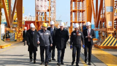 Stephen Fuhr, Canada’s secretary of state for defense procurement, center, tours production facilities at Hanwha Ocean’s Geoje shipyard with Lee Doo-hee, vice minister of national defense, left, and Kim Hee-cheul, CEO of Hanwha Ocean, second from left, on Feb. 2. [HANWHA OCEAN]